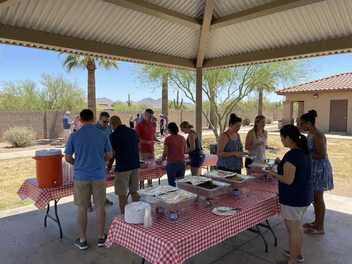 Company-picnic BBQ buffet outdoors with coworkers gathering to eat