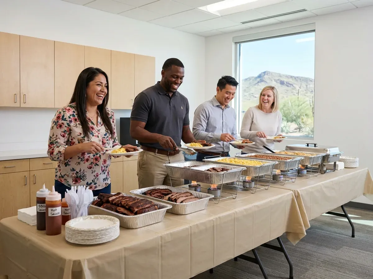 BBQ catering laid out for a Phoenix office lunch as coworkers serve plates
