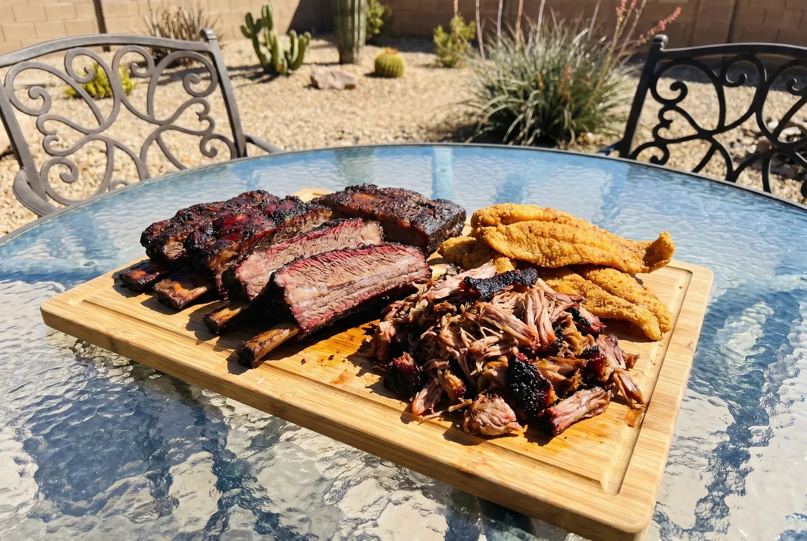 Specialty smoked beef ribs, pulled pork, and catfish on a board